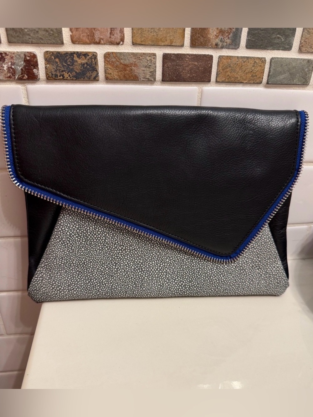 Halogen Black and White Envelope Clutch with Blue Trim. Asymmetrical front